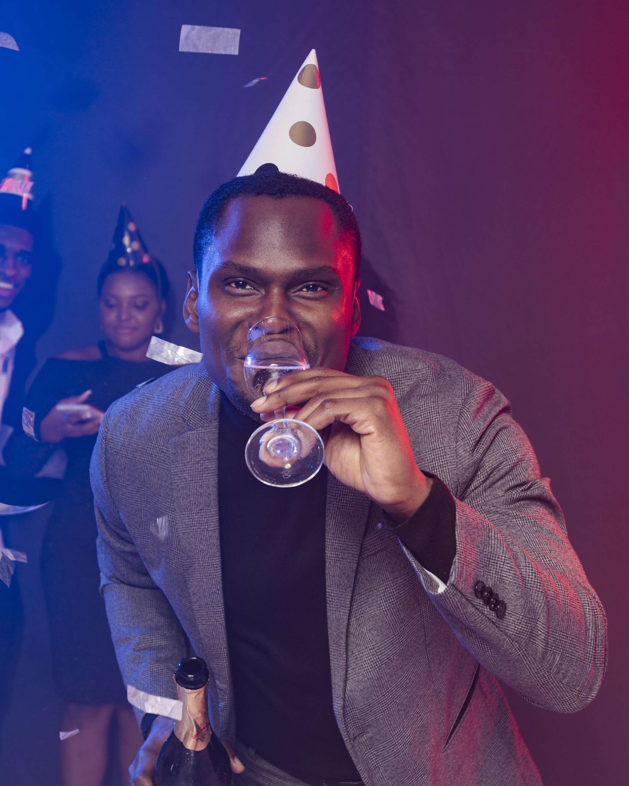 man-wearing-party-hat-drinking-champagne